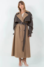 Load image into Gallery viewer, A long brown trench coat featuring a mix of vegan leather and traditional trench materials, offering a unique and chic style. 
