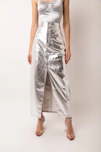 Our Silver Metallic Maxi Skirt is the skirt of the season! This high waisted maxi skirt in faux leather metallic fabric is set to become your wardrobe staple! Tailored to perfection this skirt fits like a dream and has a front slit and front fly fastening. Equally great with heels or flats this is definitely going to be the perfect summer wardrobe staple! Remix it with a chunky knit and boots in the Fall and Winter seasons.