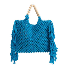 Load image into Gallery viewer, Introducing our latest addition to the family, our Blue Crochet Large Tote Bag, the perfect tote bag with both fashion and practicality. Designed with a hand knitted crochet look with fringe on the sides and wooden beads along the handle. This crochet bag is spacious enough to carry a standard size tablet and all your warm weather essentials.
