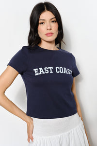 Woman wearing a navy blue t-shirt with 'East Coast' text on a white background