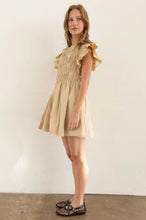 Load image into Gallery viewer, Model wearing a lightweight cotton babydoll mini dress with smocked bodice, ruffled sleeves, and a flowy skirt—perfect for staying cool in summer. The dress features hidden side pockets and a relaxed fit, ideal for casual outings, beach vacations, or warm-weather brunches.
