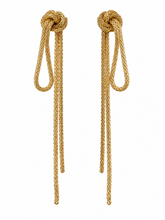 Load image into Gallery viewer, Long gold statement earrings featuring sculptural knot tops with cascading textured chain loops and asymmetrical-length drops.
