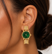 Load image into Gallery viewer, Gold statement earrings designed like miniature vintage watches with emerald-green faces, gold hands and bracelet-style detailing.
