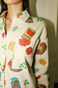 Cream-colored button-up shirt with colorful grocery and snack print, featuring short sleeves and a relaxed fit - perfect for playful summer style. Matching printed shorts sold separately. Fun, foodie-inspired fashion exclusively at Glam Expressway.