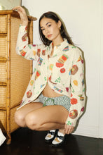 Load image into Gallery viewer, Cream-colored button-up shirt with colorful grocery and snack print, featuring short sleeves and a relaxed fit — perfect for playful summer style. Matching printed shorts sold separately. Fun, foodie-inspired fashion exclusively at Glam Expressway.
