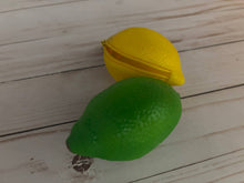 Load image into Gallery viewer, Realistic lemon-shaped coin purse with zipper, keychain ring, and bag charm attachment displayed on a wood background.

