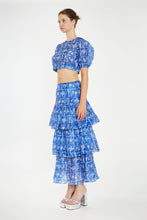 Load image into Gallery viewer, Introducing our enchanting Blue and White Floral Tiered Maxi Skirt, where elegance meets whimsy in a delightful dance of colors and patterns. Crafted with care and attention to detail, this skirt is a true ode to femininity and style.
