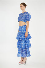 Load image into Gallery viewer, Introducing our stunning Blue and White Floral Crop Top, the perfect complement to our Blue Floral Tiered Maxi Skirt. Embrace effortless elegance with this exquisite blouse that exudes charm and sophistication.
