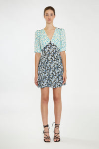 Step into summer with this adorable floral dress, featuring contrasting floral prints for a chic, 90s-inspired look. With its short sleeves, flattering V neckline, and a hem that falls just above the knee, it's perfect for any warm-weather occasion. Pair it with cowboy boots for a stylish upgrade or keep it casual with your favorite sneakers. Stay cute and on trend all season long!