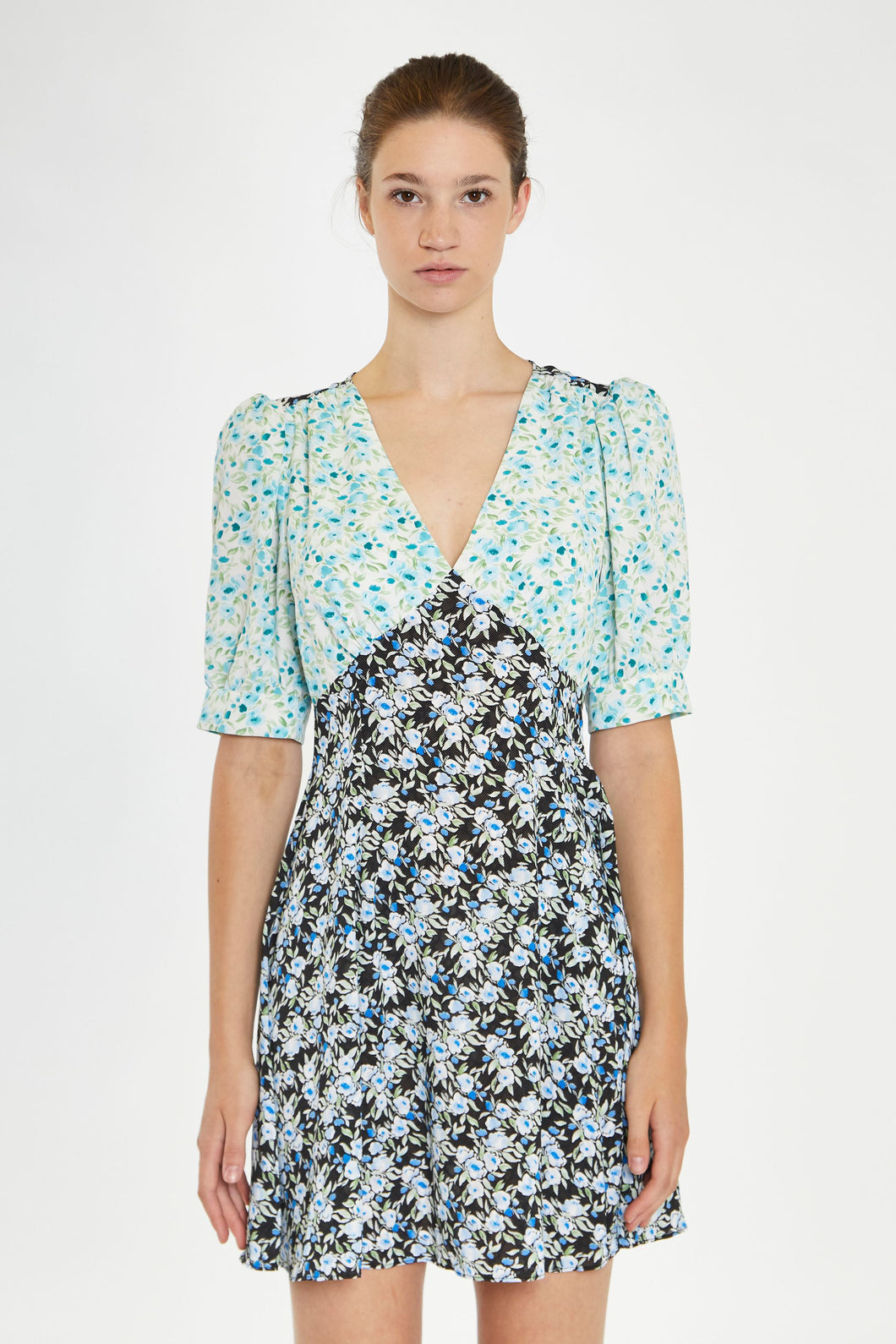 Step into summer with this adorable floral dress, featuring contrasting floral prints for a chic, 90s-inspired look. With its short sleeves, flattering V neckline, and a hem that falls just above the knee, it's perfect for any warm-weather occasion. Pair it with cowboy boots for a stylish upgrade or keep it casual with your favorite sneakers. Stay cute and on trend all season long!