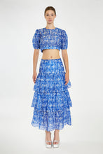 Load image into Gallery viewer, Introducing our enchanting Blue and White Floral Tiered Maxi Skirt, where elegance meets whimsy in a delightful dance of colors and patterns. Crafted with care and attention to detail, this skirt is a true ode to femininity and style.
