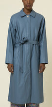 Load image into Gallery viewer, Our butter soft, light blue, vegan leather trench coat has all the standard touches that make a trench coat great like long sleeves, a shirt collar, button closure and a self tie sash belt. This lovely coat is comfortable to wear with full lining and the perfect length. Best of all its retro flair.   Style Tip: Wear our Blue Leather Trench Coat dressed up or down. Our only tip is - never take it off!
