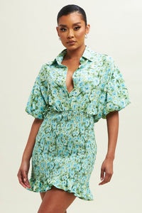 Our blue and green Floral Smocked Shirt Dress is fun, chic and feminine. This sweet dress features a collared neck, button closure, a decorative smocked skirt with a pretty frill at the hem, and is sure to become one of your go-to favorites! Dress it up or down!