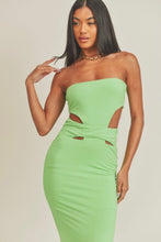 Load image into Gallery viewer, This Lime green strapless maxi dress is made from a soft and stretchy material that will conform to your curves. Its cutouts and strapless detail make for a sexy silhouette, perfect for a summer wedding or night out on the town. A solid dress with cutouts on the sides. This strapless dress has a tight cup fit and plenty of stretch. Model pictured is wearing a size small.
