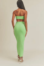 Load image into Gallery viewer, This Lime green strapless maxi dress is made from a soft and stretchy material that will conform to your curves. Its cutouts and strapless detail make for a sexy silhouette, perfect for a summer wedding or night out on the town. A solid dress with cutouts on the sides. This strapless dress has a tight cup fit and plenty of stretch. Model pictured is wearing a size small.
