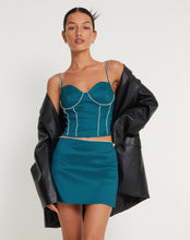 Load image into Gallery viewer, Our Blue Rhinestone Corset Top is aqua blue, with a slightly cropped fit and rhinestone crystal detail on the straps and bodice. Wear this beautifully crafted corset top when you want to stand out.   Style Tip: Wear our Blue Rhinestone Corset Top with cargo pants or loose jeans and heels for a casual look. Or wear it under a structured suit for a dressier look. 
