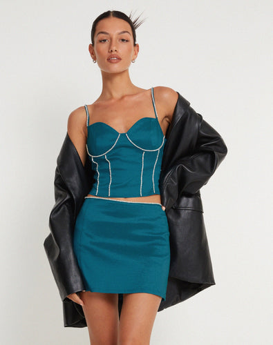 Our Blue Rhinestone Corset Top is aqua blue, with a slightly cropped fit and rhinestone crystal detail on the straps and bodice. Wear this beautifully crafted corset top when you want to stand out.   Style Tip: Wear our Blue Rhinestone Corset Top with cargo pants or loose jeans and heels for a casual look. Or wear it under a structured suit for a dressier look. 