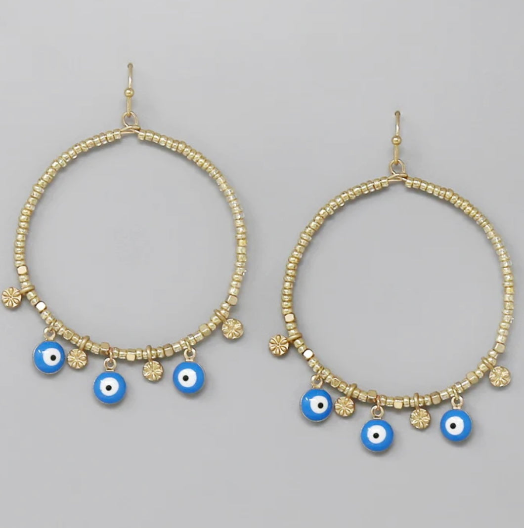 Our All Seeing Eye Beaded Hoop Earrings are lightweight, beautiful and unique. These beautiful drop earrings are made with lead compliant plated metal wrapped in gold beads, with a fish hook closure. The All Seeing Eye Beaded Hoops measure 2.5