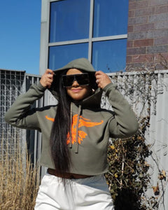 This is luxury loungewear! Our Army Green Cropped Hoodie is extremely soft and incredible quality. This stylish hoodie was designed specifically for our store with a metallic orange bird in flight on the front and a distressed hem at the waist. Made exclusively by Craig Anthony Miller for Glam Expressway! sizes come in Small - XL. Dress it up or down!